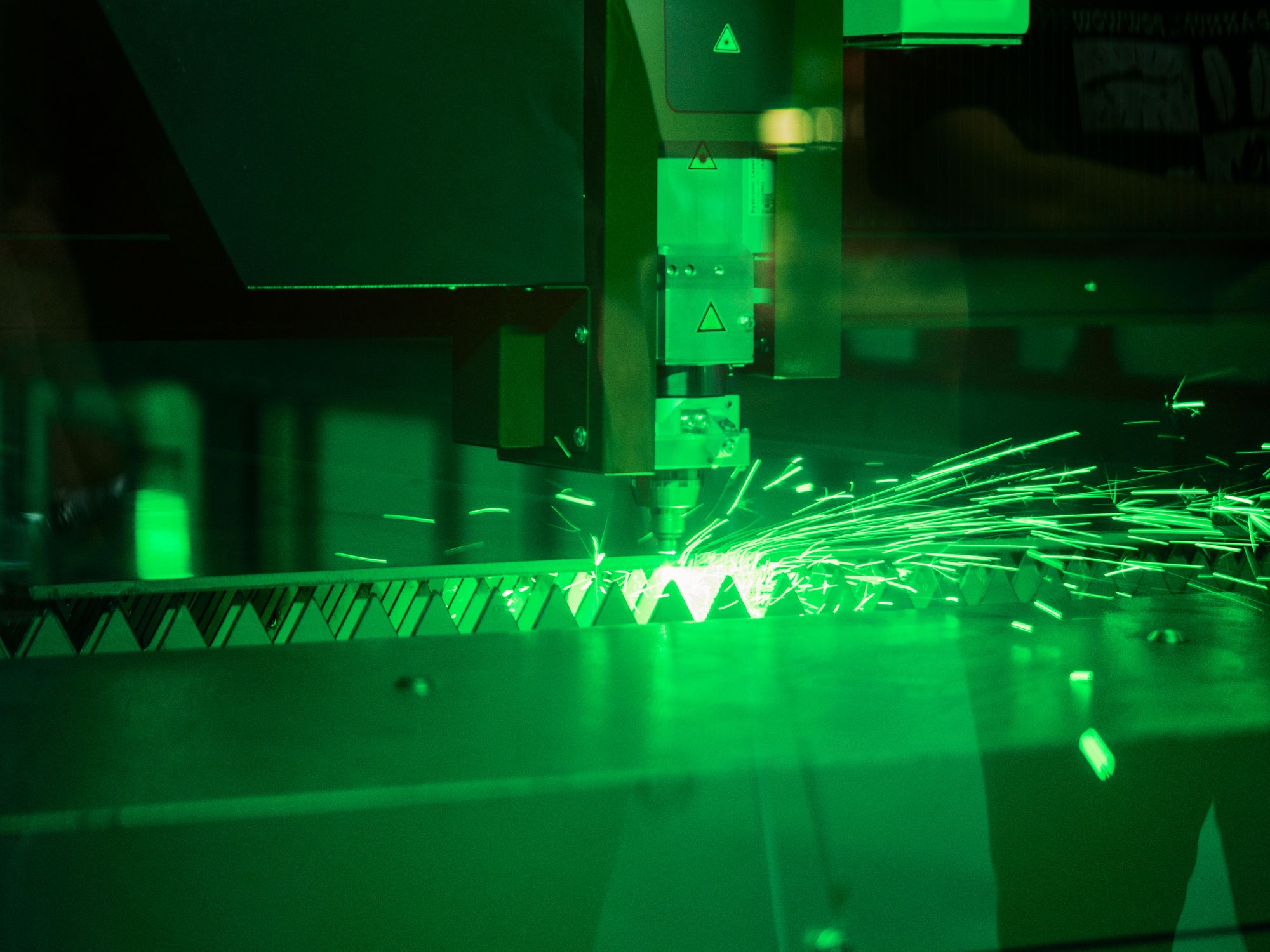 A laser cutting a sheet of metal