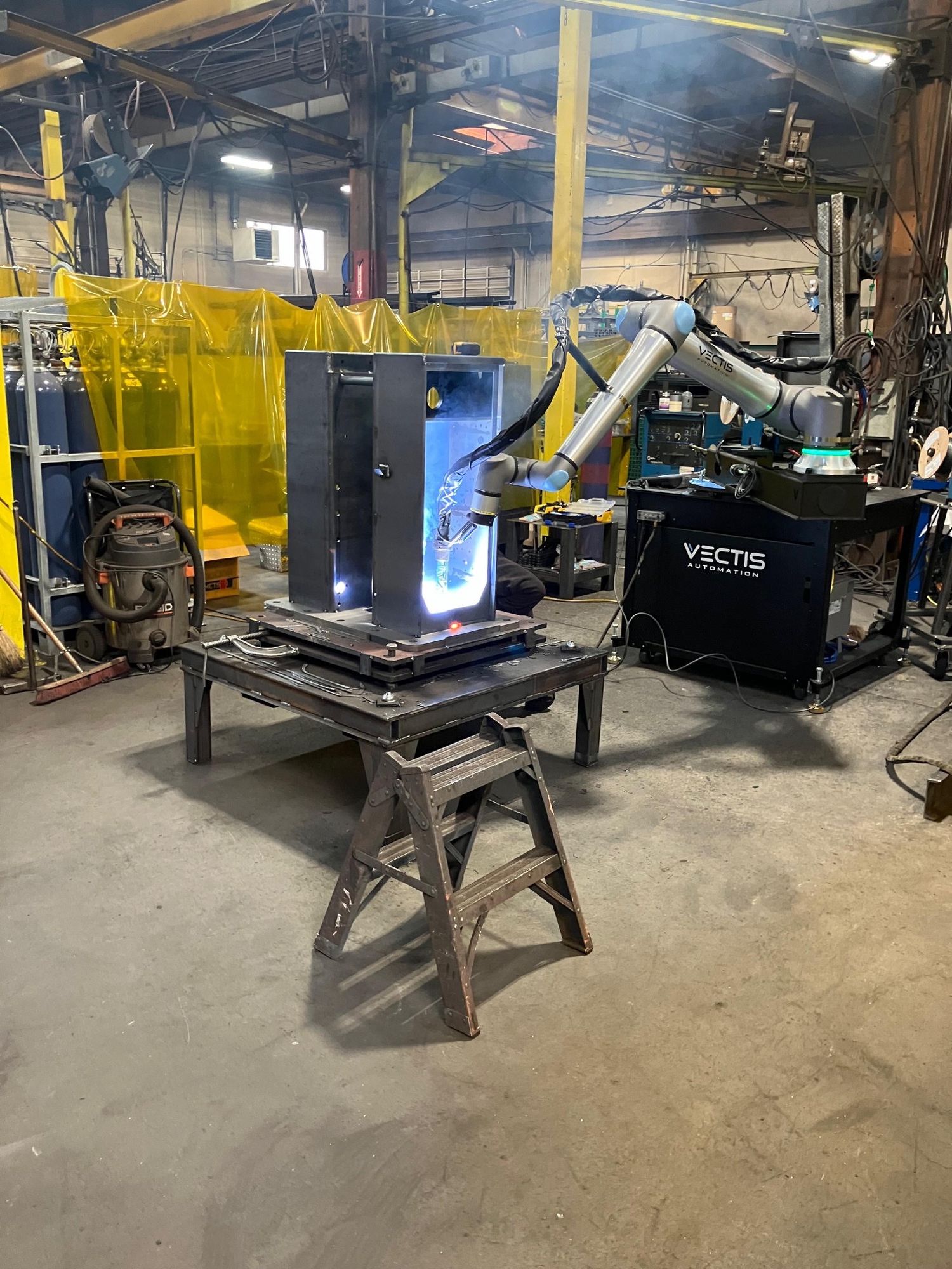 Cobot fabrication tool welds a base assembly